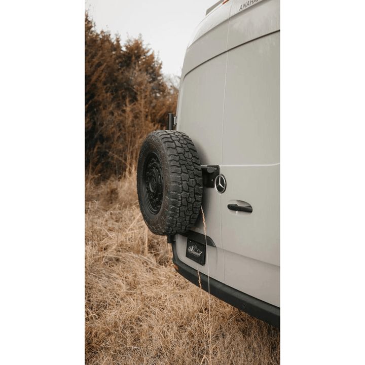 Side of Sprinter van with installed tire carrier